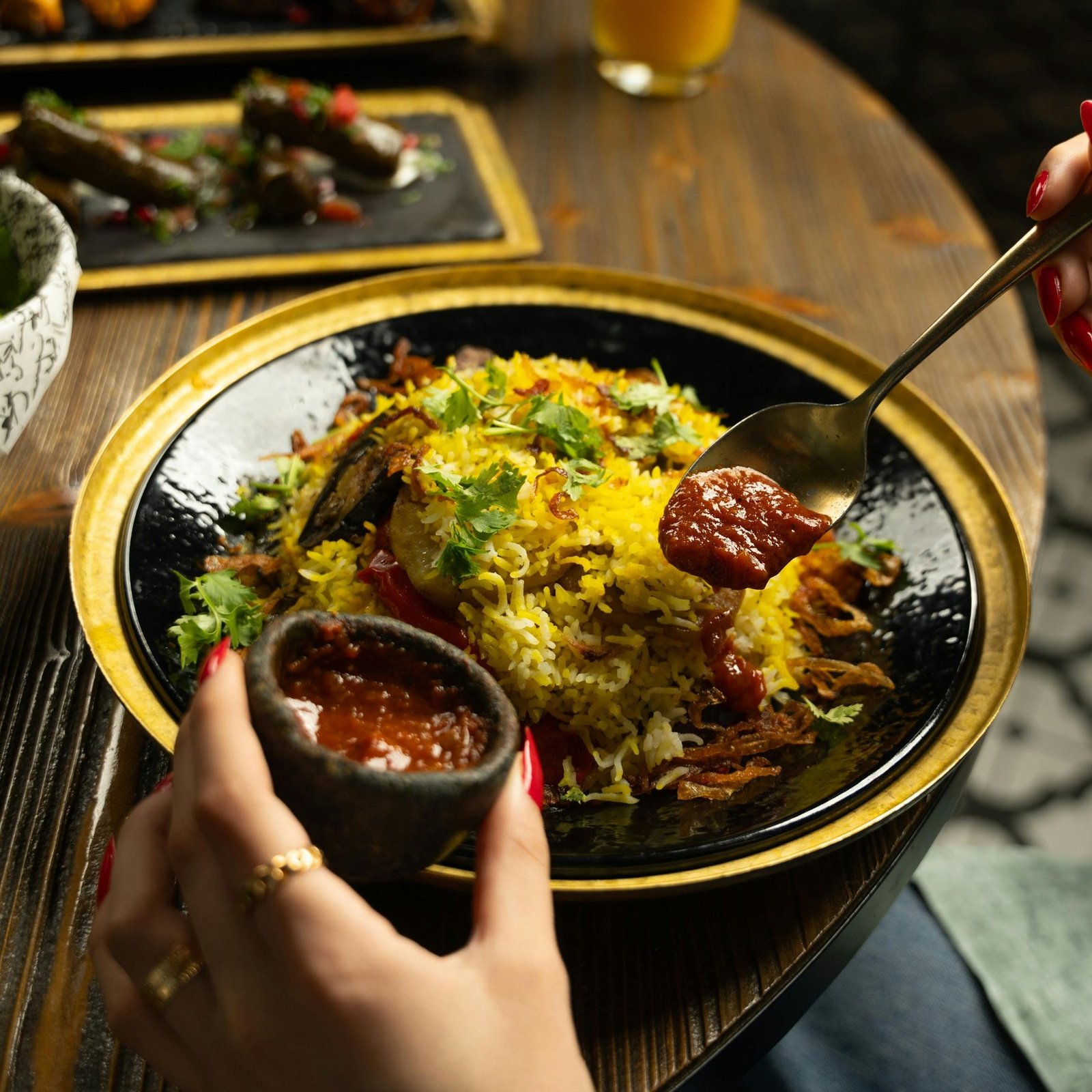 Al Zayt Biryani: saffron-yellow long-grain rice, slow-steamed with Kerala spices, fresh coriander and house-made tomato sauce
